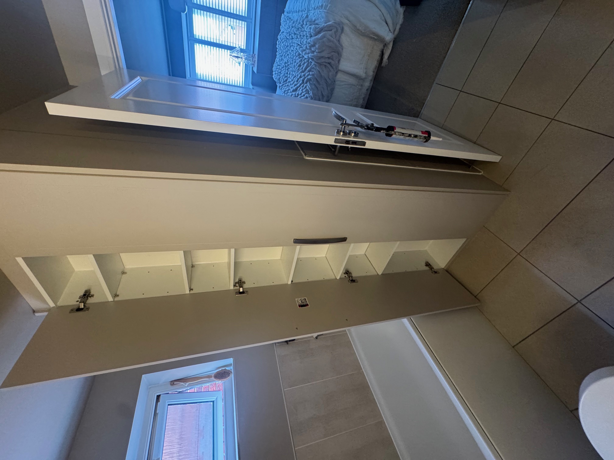 Adjustable shelving inside custom bathroom unit